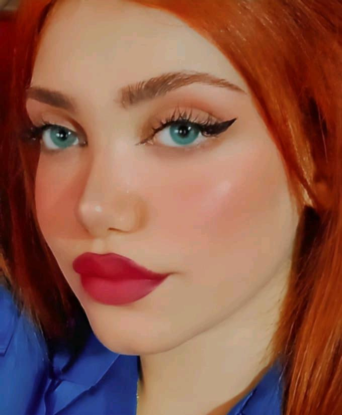 SalaChat host Ruby from Syria with red hair and a blue shirt